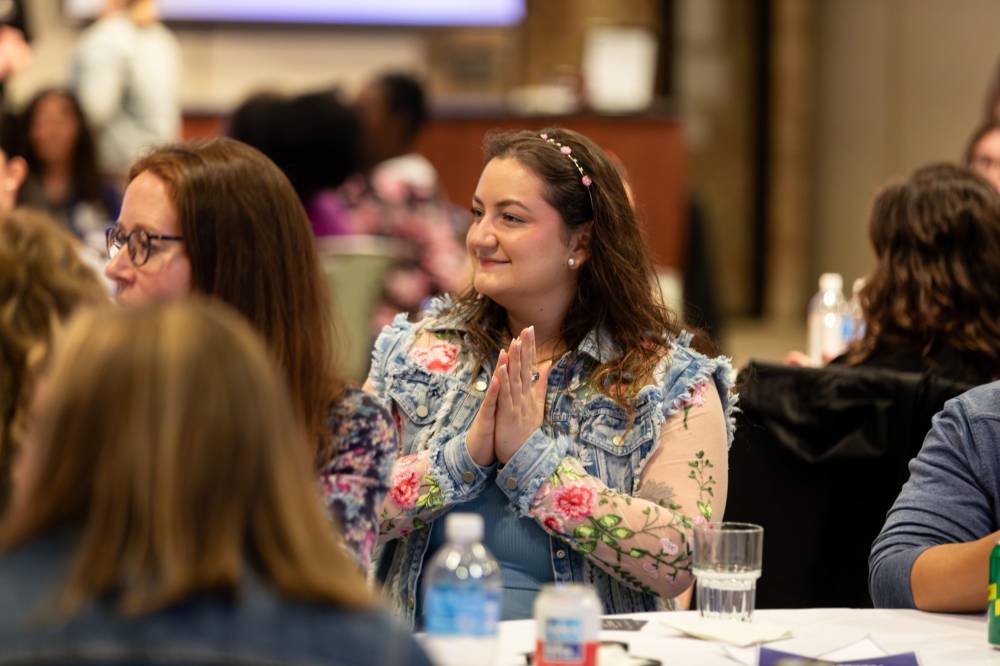 An alum clapping at the event.